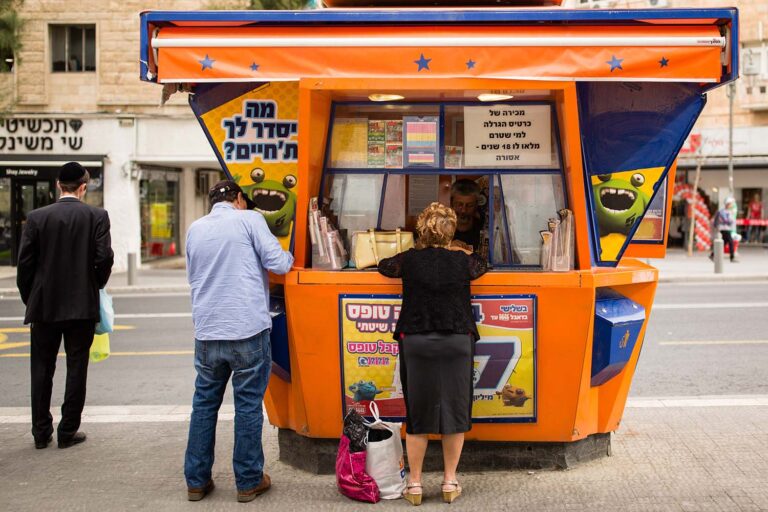 Israelis playing lottery games at a Mifal Hapais lottery booth. (Photo: Korina Keren / Flash90)
