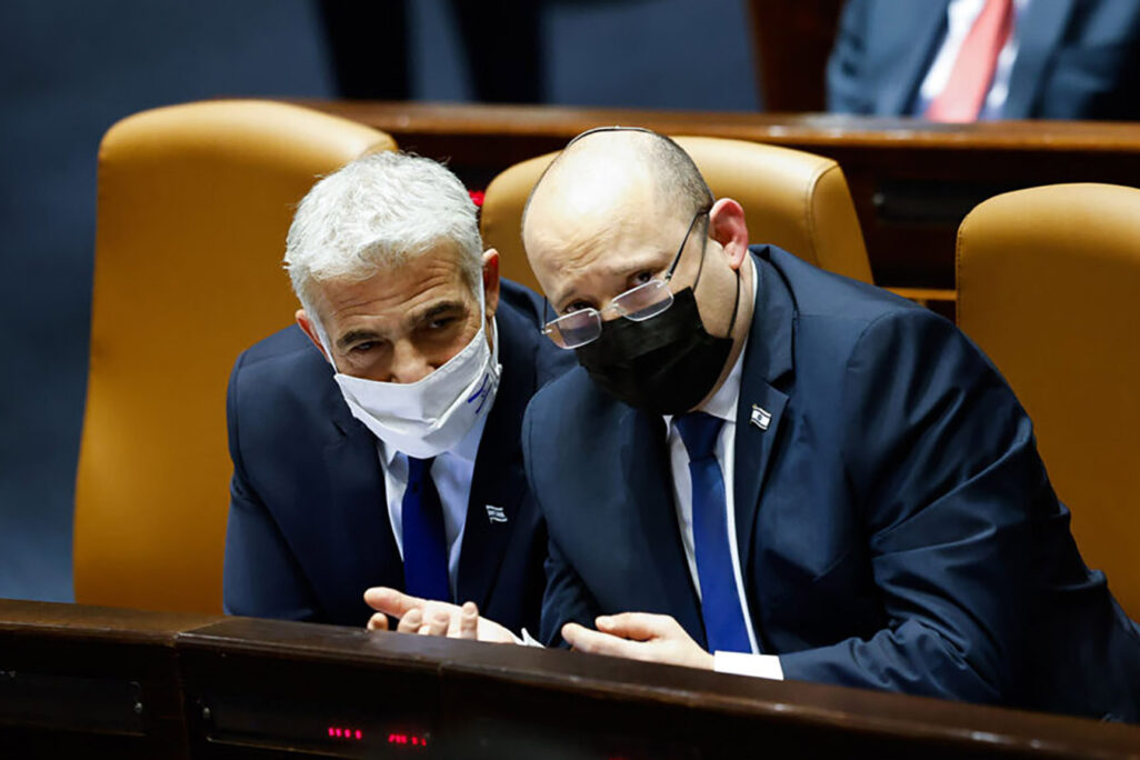 Israeli prime minister Naftali Bennett and Minister of Foreign Affairs Yair Lapid attend a plenum session in the assembly hall of the Knesset. (Photo: Olivier Fitoussi/Flash90)