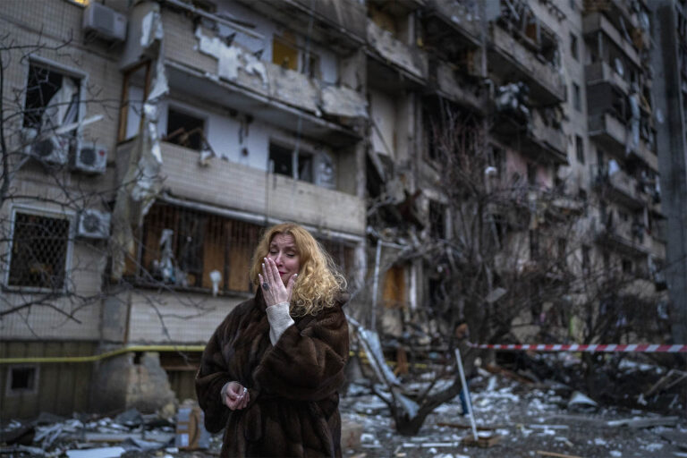 Natali Sevriukova reacts next to her house following a rocket attack in the city of Kyiv, Ukraine, Friday, Feb. 25, 2022. (Photo: AP Photo/Emilio Morenatti)