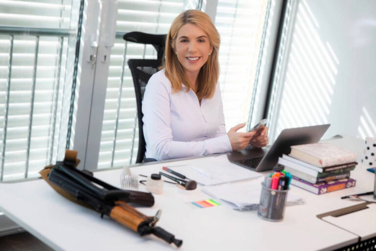 Member of Parliament Kira Rudik with a Kalashnikov rifle on her office desk in her home. “I’m ready to use it,” she says. (Photo: Facebook)