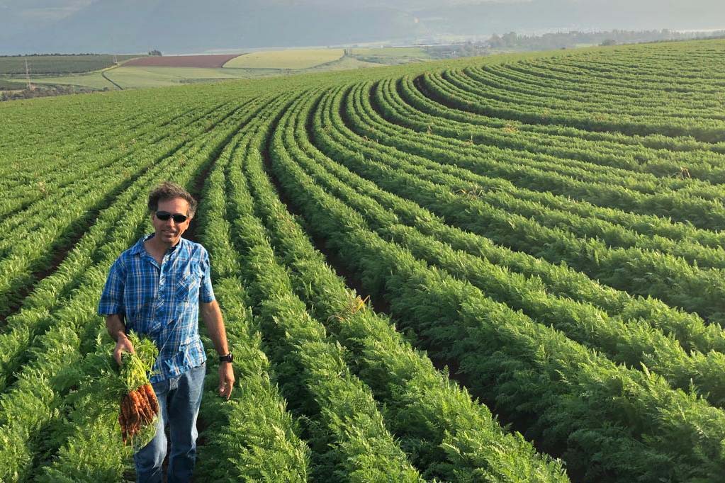 Farmer Ronen Albaz in front of his carrot field. (Photo: Liav Albaz)