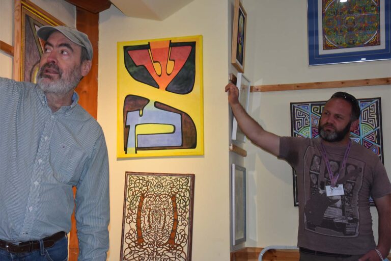 Tour guide Peter Gokhbat (right) with Kabbalah artist David Friedman in his gallery. (Photo: Hadas Yom Tov)