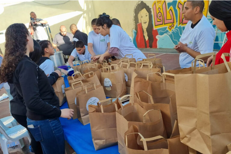 Youth packing food deliveries in the youth center. “It’s a month of helping and doing good.” (Photo: Ahmad Hasona)