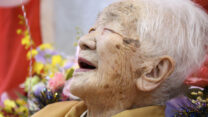 FILE PHOTO: Kane Tanaka, born in 1903, smiles as a nursing home celebrates three days after her 117th birthday in Fukuoka, Japan, in this photo taken by Kyodo January 5, 2020. Mandatory credit Kyodo/via REUTERS ATTENTION EDITORS - THIS IMAGE WAS PROVIDED BY A THIRD PARTY. MANDATORY CREDIT. JAPAN OUT. NO COMMERCIAL OR EDITORIAL SALES IN JAPAN./File Photo