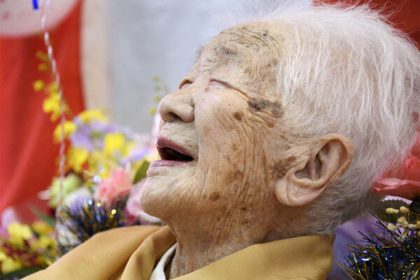 FILE PHOTO: Kane Tanaka, born in 1903, smiles as a nursing home celebrates three days after her 117th birthday in Fukuoka, Japan, in this photo taken by Kyodo January 5, 2020. Mandatory credit Kyodo/via REUTERS ATTENTION EDITORS - THIS IMAGE WAS PROVIDED BY A THIRD PARTY. MANDATORY CREDIT. JAPAN OUT. NO COMMERCIAL OR EDITORIAL SALES IN JAPAN./File Photo