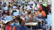 Matumelo Manosa, center, works in a garment factory in Maseru, Lesotho, Thursday, Feb. 24, 2022. When the coronavirus pandemic hit the world two years ago, the global fashion industry crumpled when faced with collapsing demand, brands canceled orders worth billions of dollars and few felt the effects so harshly as the tens of millions of workers, most of them women, who stitched the world's clothes. (AP Photo/Neo Ntsoma)