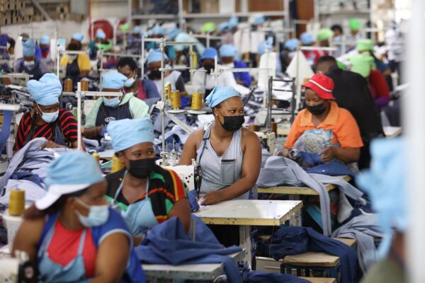 Matumelo Manosa, center, works in a garment factory in Maseru, Lesotho, Thursday, Feb. 24, 2022. When the coronavirus pandemic hit the world two years ago, the global fashion industry crumpled when faced with collapsing demand, brands canceled orders worth billions of dollars and few felt the effects so harshly as the tens of millions of workers, most of them women, who stitched the world's clothes. (AP Photo/Neo Ntsoma)