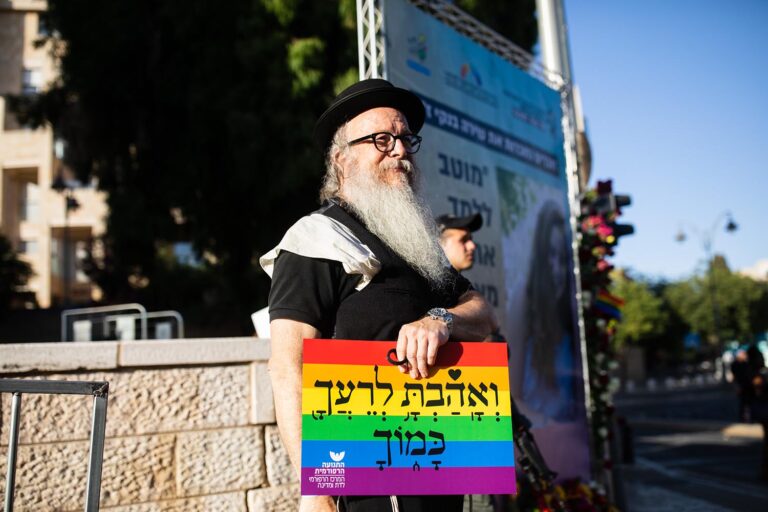 “Love your neighbor as yourself.” Yisrael Kimmel standing next to the memorial to Shira Banki (Photo: David Frenkel)