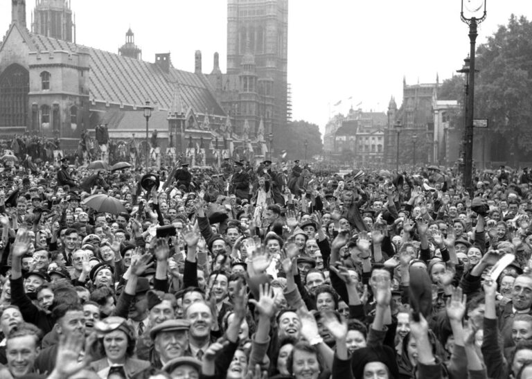המוני בריטים שהתאספו ברחבת הפרלמנט בלונדון, לחגוג את ניצחון בעלות הברית על יפן במלחמת העולם השנייה, 15 באוגוסט 1945. בין החוגגים, היו גם הנסיכה אליזבת ואחותה מרגרט (צילום: AP)