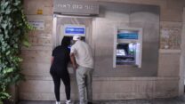 מושכים כסף מזומן מכספומט (צילום אילוסטרציה: אור גואטה)