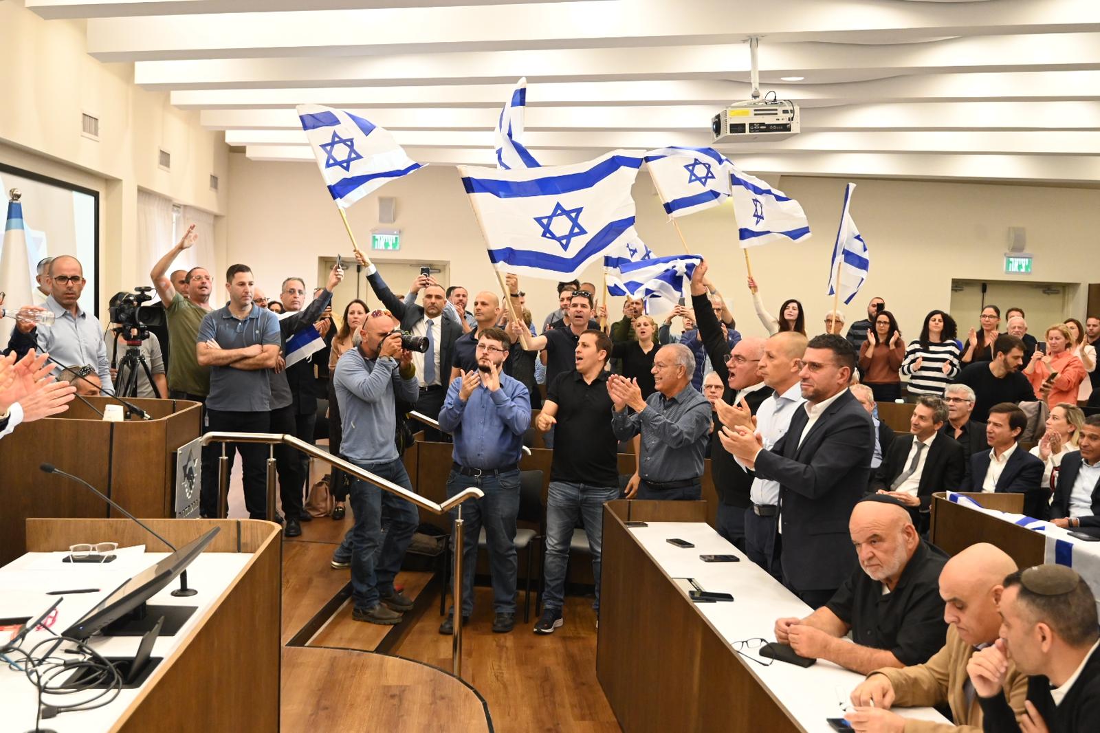 Attendees wave Israeli flags at the press conference announcing the strike (Photo: Histadrut spokesperson).