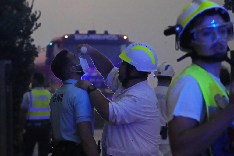 ליסבון, פורטוגל. פראמדיק שוטף את עיניו של שוטר (צילום: AP Photo/Armando Franca)