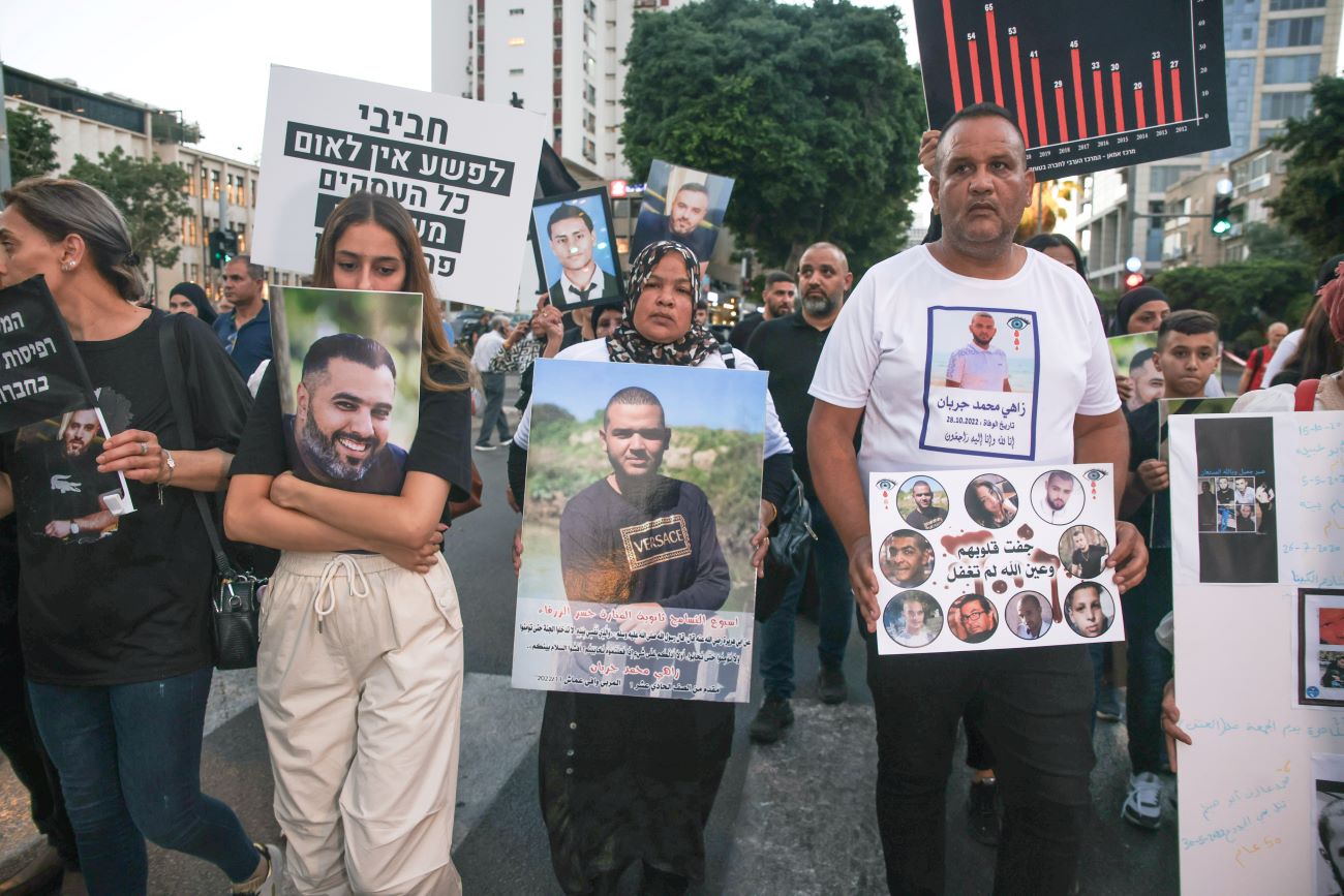 Protesters carry pictures of deceased loved ones at the March of the Dead (Photo: Kadia Levy).