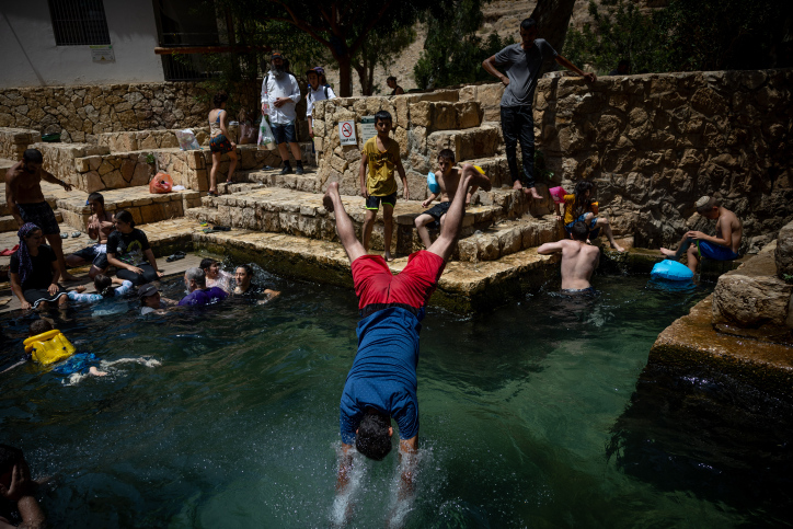 רוחצים בעין פרת בוואדי קלט (צילום: יונתן זינדל/פלאש90)