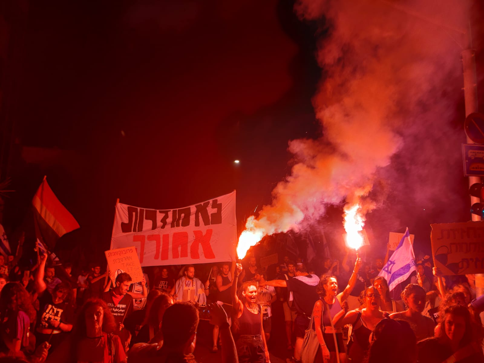 פעילות מחאת הסטודנטים עם אבוקות ושלט &quot;לא חוזרות אחורה&quot; במחאה בכיכר פריז בירושלים (צילום: מחאת הסטודנטים)