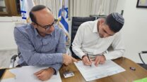 שר התקשורת שלמה קרעי (מימין) חותם יחד עם מנכ"ל משרדו מימון שמילא על צו סגירה לאל מיאדין (צילום: דוברות משרד התקשורת)