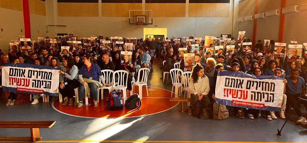 כיסאות ריקים עם תמונות החטופים בכינוס המועצה החינוכית של הנוער העובד והלומד בדימונה (צילום: הנוער העובד והלומד)