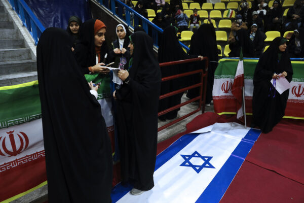 נשים דורכות על דגל ישראל בעצרת לקראת הבחירות באיראן (צילום: AP Photo/Vahid Salemi)