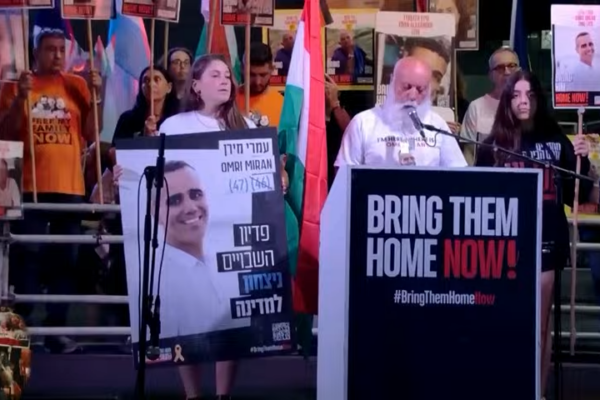 דני מירן, אביו של החטוף עמרי מירן, נושא תפילה לשלום החיילים והחטופים בעצרת הבינלאומית בכיכר החטופים (צילום מסך: מטה משפחות החטופים)