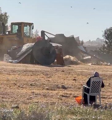 Rasmia Abu Issa, the aunt of Osama Abu Issa who was murdered near Kibbutz Reim on October 7, watches the destruction of her home (photo: Council of Unrecognized Villages)