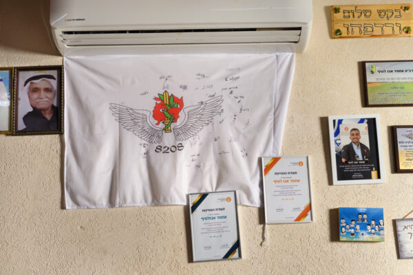 בית משפחתו של אחמד אבו-לטיף ז&quot;ל. תעודות הוקרה ודגל הגדוד שלו במילואים, מביקור של חבריו במהלך המלחמה (צילום: יונתן בלום)