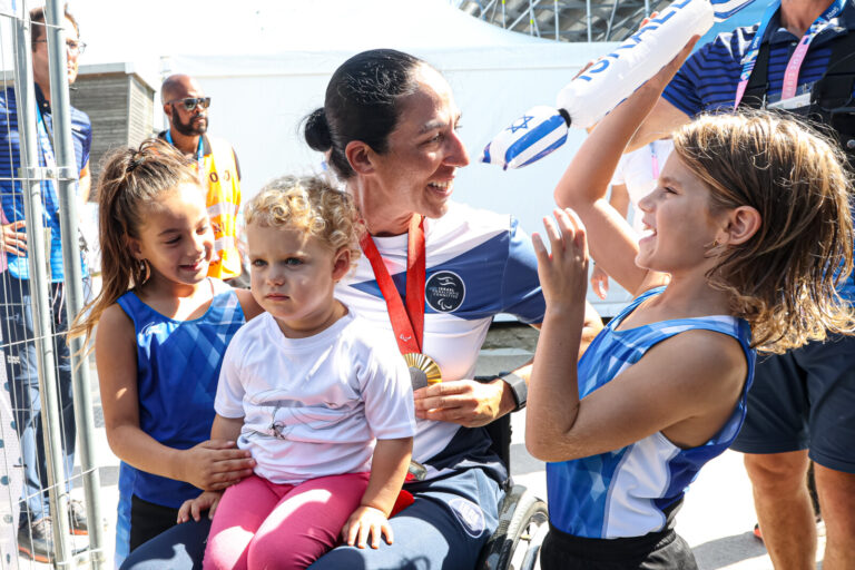 מורן סמואל חוגגת עם משפחתה את הזכייה במדליית הזהב במשחקים הפראלימפיים בפריז. "למרות הקושי וסידורי אבטחה קפדניים, קיבלתי חצי שעה של אוויר לנשימה מהחיבוקים שהם מרעיפים עלי" (צילום: לילך וייס רוזנברג)