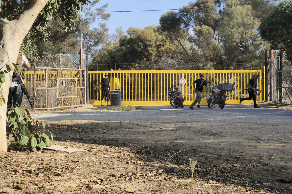 מחבלים חוצים גדר של קיבוץ במתקפת 7 באוקטובר (צילום: AP Photo)