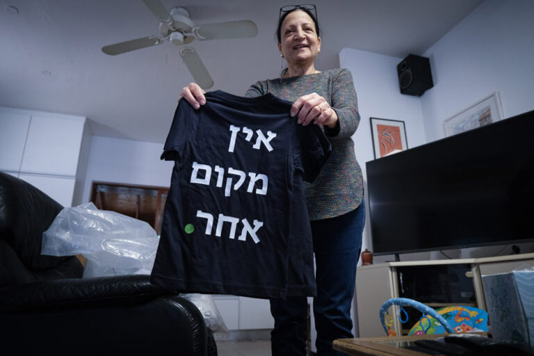 Ruthie Kalvari of Kibbutz HaGoshrim. The shirt she is holding reads, “There’s no other place.”  (Photo: David Tversky)