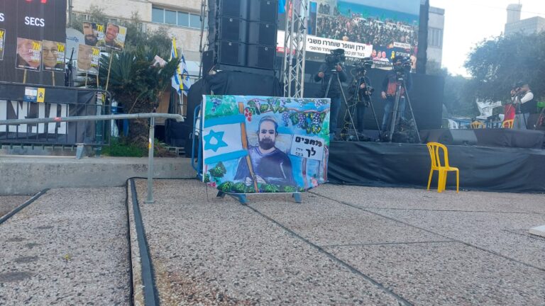 שלט עם ציור של ירדן ביבס בכיכר החטופים (צילום: מיכל מרנץ)