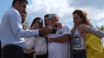 סיימון באום (במרכז) וחברי קיבוץ ניר עוז צופים במפגש הראשון של ירדן ביבס עם בני משפחתו לאחר שחרורו מהשבי סמוך לבניין המגורים של חברי הקיבוץ בקריית גת (צילום: דוד טברסקי)