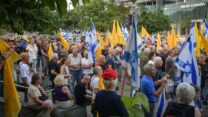 טייסים לשעבר וטייסי מילואים של חיל האוויר, יחד עם מפגינים נוספים, משתתפים במחאה נגד המשך המלחמה ולמען שחרור החטופים סמוך לבסיס הקריה בת"א, אוגוסט 2025 (צילום: אבשלום ששוני/Flash90)