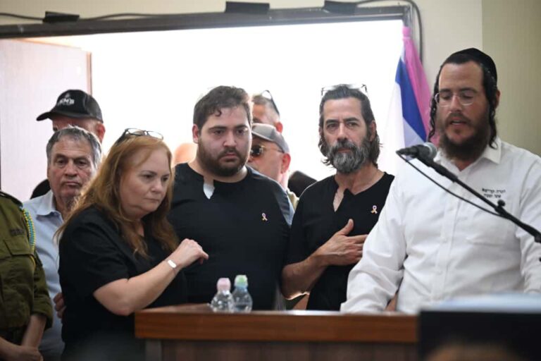 Inbar Hayman's family at her funeral: her father Haim (right, in a black shirt), brother Ido and mother Yifat (Photo: Paulina Pattimer)