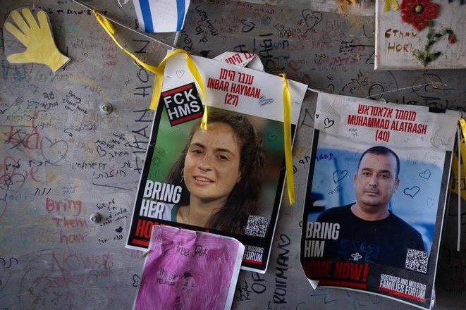 Photos of fallen hostages on a wall in Hostage Square calling for their return for burial in Israel (Photo: Miriam Elster/Flash90)