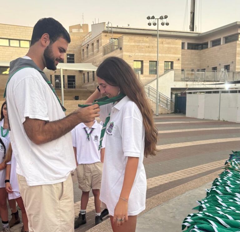Oren receives the neckerchief from Benyamini, symbolizing her selection to lead the counselor training preparatory course (Photo: Private album).