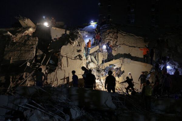 Emergency services work at the site of a collapsed building after an earthquake, in Caracas, Venezuela, June 24. REUTERS/Gaby Oraa