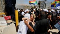 אישה דרוזית מסוריה פוגשת את אחותה בצד הישראלי של הגבול בעיצומו של הסכסוך המתמשך באזורי הדרוזים בסוריה, 16 ביולי 2025 (צילום: עמאר עוואד/רויטרס)