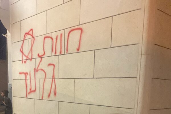 כתובות גרפיטי בעברית ומגן דוד שרוססו על מבנה בא-תוואני