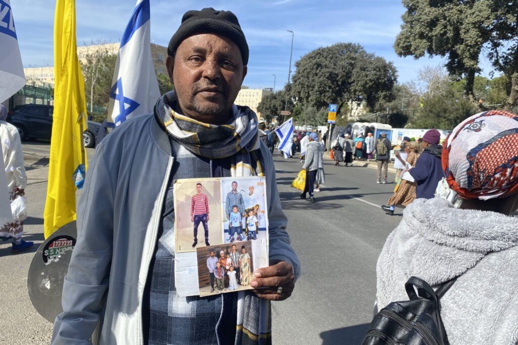 מוחה עם תמונות קרוביו שממתינים באתיופיה מהפגנה בקריאה להמשך העלייה מאתיופיה מול לשכת רה"מ בירושלים, ינואר 2026 (צילום: יהל פרג') מוחה עם תמונות קרוביו שממתינים באתיופיה מהפגנה בקריאה להמשך העלייה מאתיופיה מול לשכת רה"מ בירושלים, ינואר 2026 (צילום: יהל פרג')